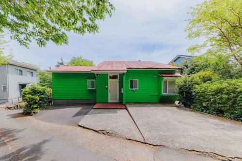 a green house with a red roof at Izukogen Yacyonosato Tokiwaso - Vacation STAY 19465 in Ito