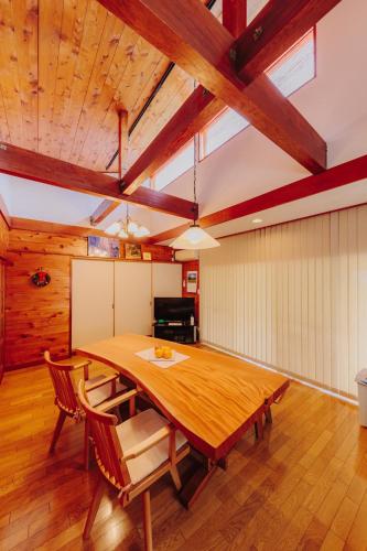 a large dining room with a wooden table and chairs at Izukogen Yacyonosato Tokiwaso - Vacation STAY 19465 in Ito