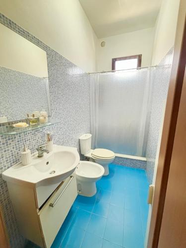 a bathroom with a sink and a toilet and a mirror at Mori & Zagara in Fanusa