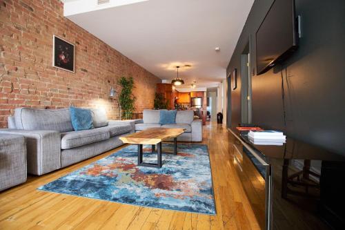 a living room with a couch and a table at Le Metro Mont-Royal by HomeInMontreal in Montreal