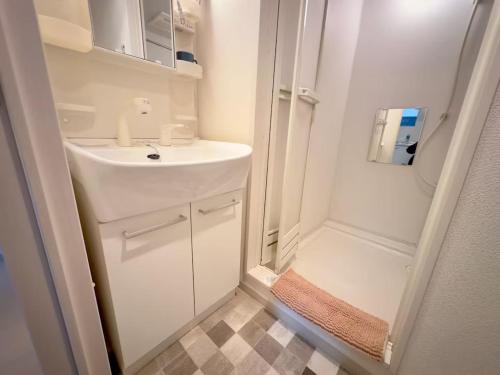 a small bathroom with a sink and a shower at Park Hills OM Chuo 12 - Vacation STAY 19390 in Sapporo
