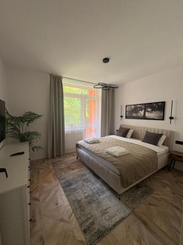 a bedroom with a large bed and a window at LUX 3 bedroom apartman in Trenčín