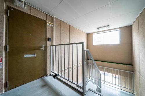 a hallway with a door and stairs in a building at Silk Coat 403 - Vacation STAY 19404 in Chitose