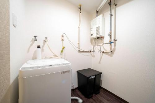 a bathroom with a sink and a washing machine at Silk Coat 403 - Vacation STAY 19404 in Chitose