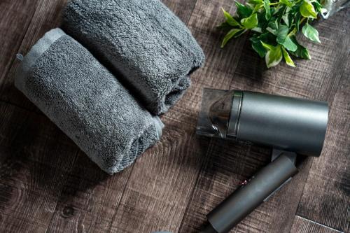 a hair dryer on a wooden table next to a towel at Silk Coat 403 - Vacation STAY 19404 in Chitose