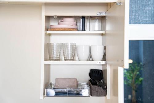 a cupboard filled with dishes and bowls and plates at Silk Coat 403 - Vacation STAY 19404 in Chitose