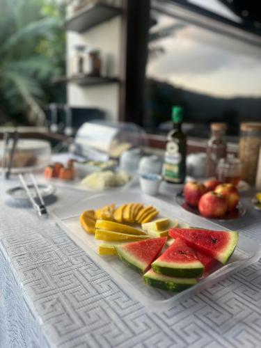 a table topped with fruit on a cutting board at Fauna in Praia do Bananal