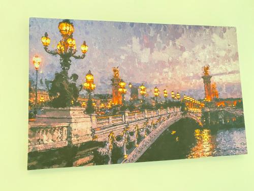 a painting of a bridge over a river with lights at Apartamento la Isla 2-Coveñas in Coveñas