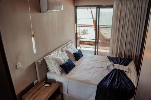 a bedroom with a large bed with a window at Beira Mar Fortaleza Landscape in Fortaleza