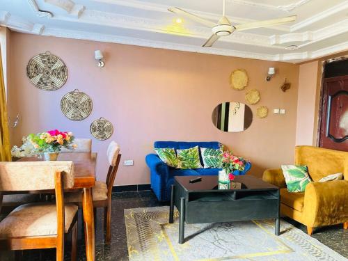 a living room with a blue couch and a table at Downtown 3 Bedroom Luxury - Central Walkable to Everything in Dar es Salaam