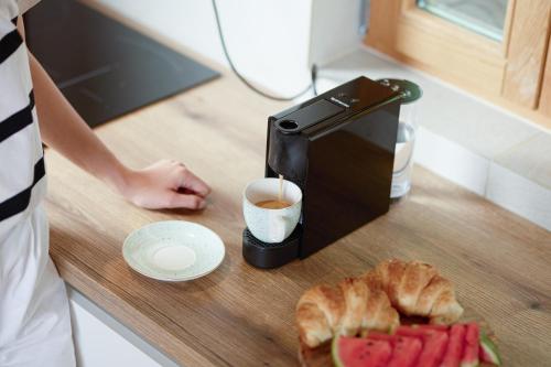 a person is making a cup of coffee on a counter at Rustique 1952 in Šiljakovina