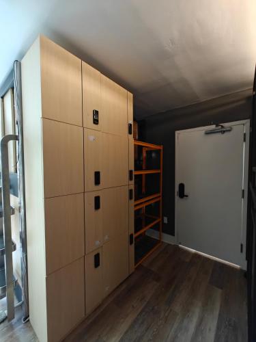 a room with lockers and a door in a room at I Street Capsule Hostel in Washington