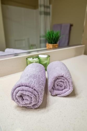 two purple towels sitting on a counter in front of a mirror at Modern 1bd apt in Marina del Rey w Free Parking in Los Angeles