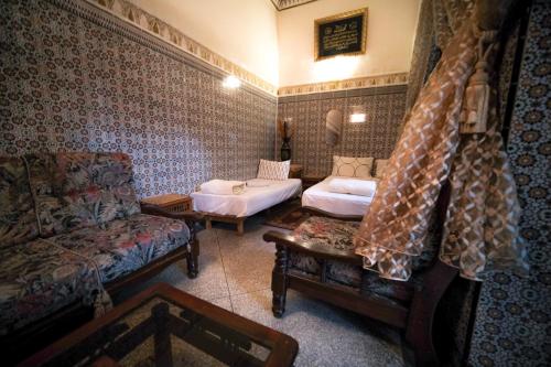 a living room with two beds and a couch at Dar Yassine in Rabat
