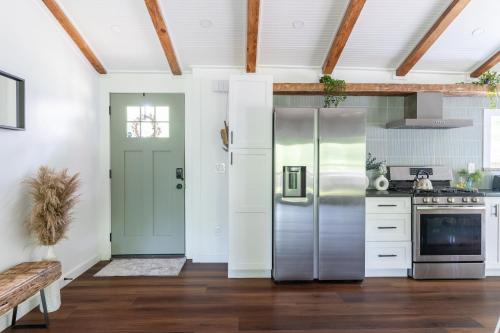 a kitchen with a stainless steel refrigerator at Tranquility Pond Cabin - Nature Retreat on 5 Acres in Buford