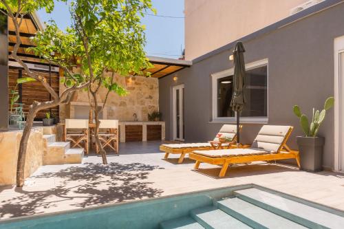 a patio with a pool and a table and a couch at Sofia Villa in Krousón