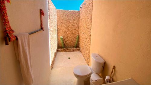 a small bathroom with a toilet in a room at Hotel Wayira Beach by On vacation in Ríohacha