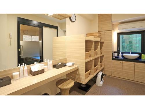 a bathroom with a sink and a counter with a mirror at Smile Hotel Kawaguchi - Vacation STAY 76839v in Kawaguchi