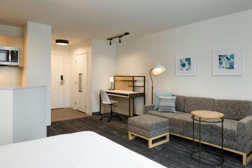 a living room with a couch and a desk at TownePlace Suites Dulles Airport in Sterling