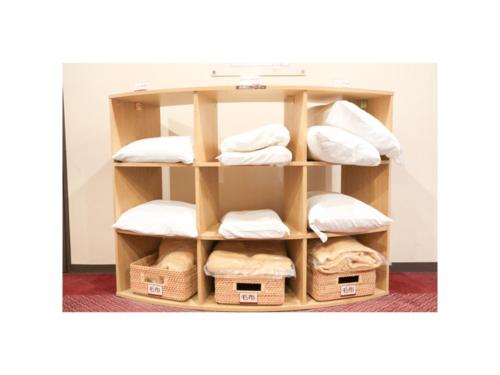 a shelf with towels and baskets in a room at Smile Hotel Sendai Kokubuncho - Vacation STAY 77739v in Sendai