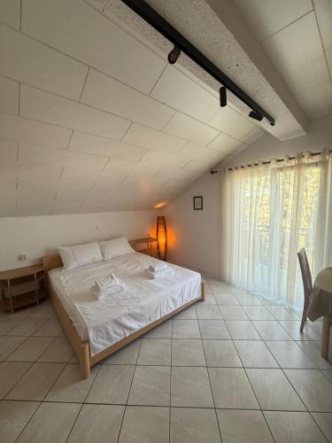 a bedroom with a large white bed in a room at Hotel Restaurant Sjor Luka Turanj in Turanj