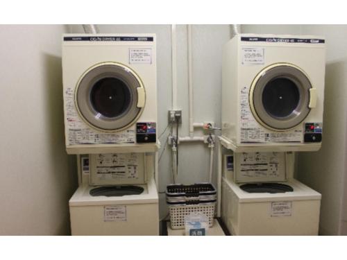 a laundry room with two washing machines on display at Smile Hotel Sendai Kokubuncho - Vacation STAY 77697v in Sendai