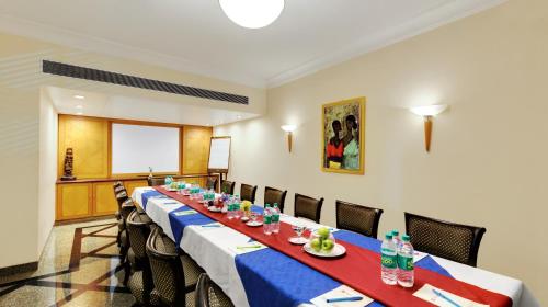 a conference room with a long table and chairs at Ambassador Ajanta Hotel, Aurangabad in Aurangabad
