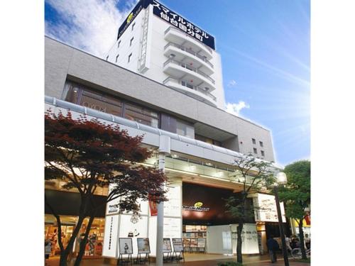 a tall white building with a sign on it at Smile Hotel Sendai Kokubuncho - Vacation STAY 77742v in Sendai