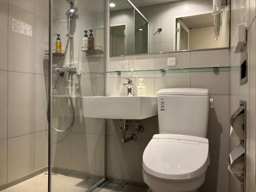 a bathroom with a toilet and a sink at Smile Hotel Hiroshima - Vacation STAY 77672v in Hiroshima