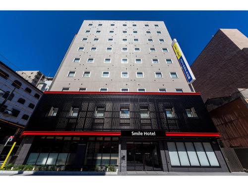 a tall building with a sign on the front of it at Smile Hotel Hiroshima - Vacation STAY 77684v in Hiroshima
