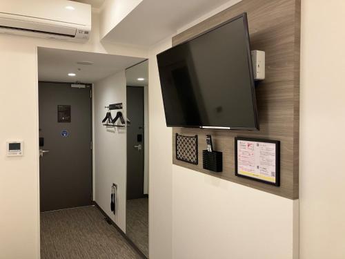 a flat screen tv on a wall in a hallway at Smile Hotel Hiroshima - Vacation STAY 77684v in Hiroshima