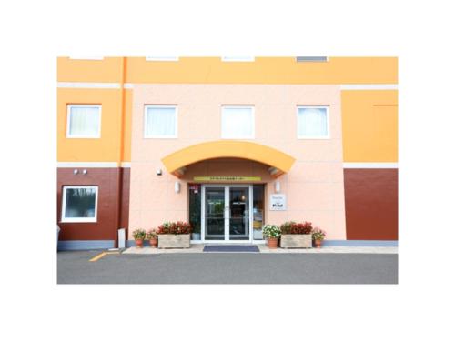 a building with the entrance to a hospital at Smile Hotel Sendai Izumi Inter - Vacation STAY 77955v in Sendai