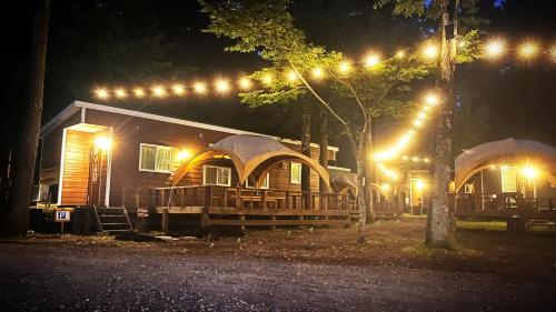 a cabin at night with lights on it at Work Shop Camp Resort Forest and Lake Paradise - Vacation STAY 78005v in Fujikawaguchiko