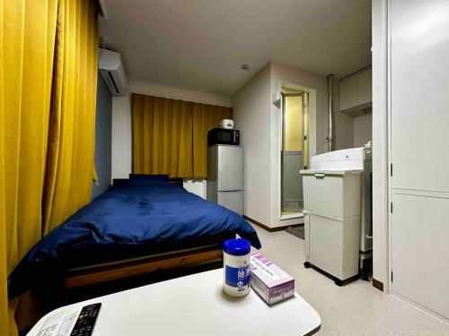 a small room with a bed and a table at Coop Sunlight - Vacation STAY 19687 in Sapporo