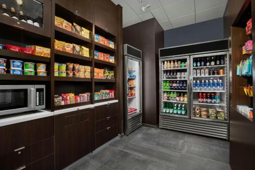a grocery store aisle with a refrigerator and drinks at Courtyard by Marriott Atlanta Kennesaw in Kennesaw