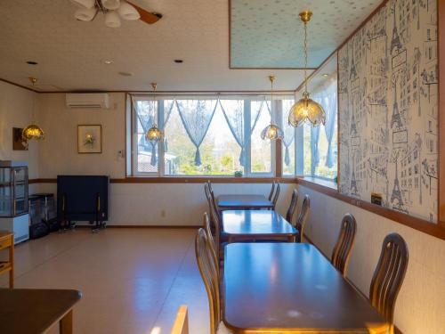 a dining room with tables and chairs and a window at Nasu First Villa - Vacation STAY 81161v in Nasu-yumoto
