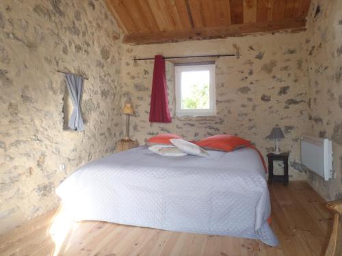 a bedroom with a white bed and a window at chambres du Domaine de Bombes in Mostuéjouls