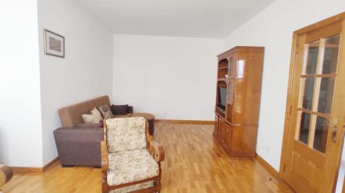 a living room with a couch and a chair at A&B Apartments - Afonso in Macedo de Cavaleiros