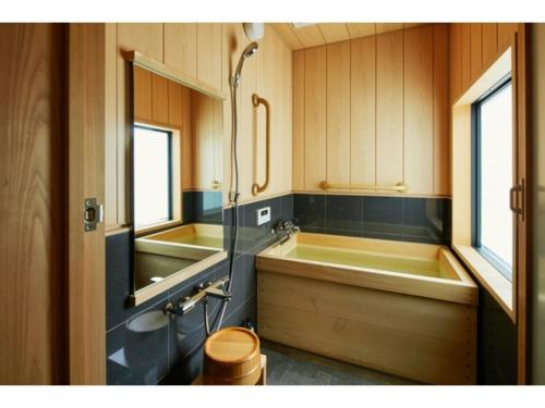 a bathroom with a tub and a sink and a shower at TSUBOMI luxury Inn Shimabara Bettei 2 - Vacation STAY 83403v in Kyoto