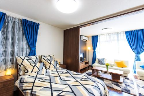 a bedroom with a bed and a couch at Prosper No, 40 - Vacation STAY 19720 in Nagoya