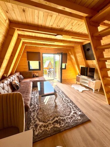 a living room with a couch and a table at Villa Roi 3 in Ferizaj