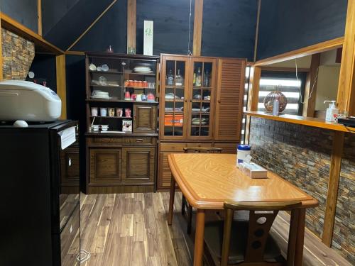a kitchen with wooden cabinets and a wooden table at Kominka Mimi - Vacation STAY 19741 