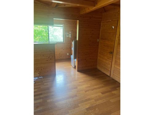 an empty room with wooden walls and a window at Ume Camp Mura - Vacation STAY 88888v in Saiki