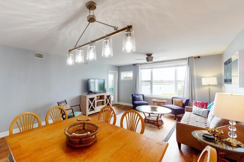 a dining room and living room with a table at Turn of River 4F in Folly Beach