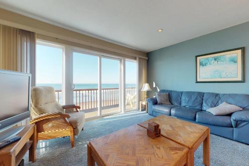 a living room with a couch and a table at Pacific Sands Resort #22 in Neskowin
