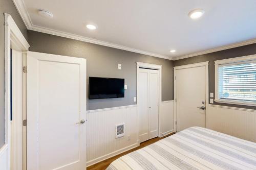 a bedroom with a bed and a flat screen tv at Pacific Sands Unit #1 in Neskowin