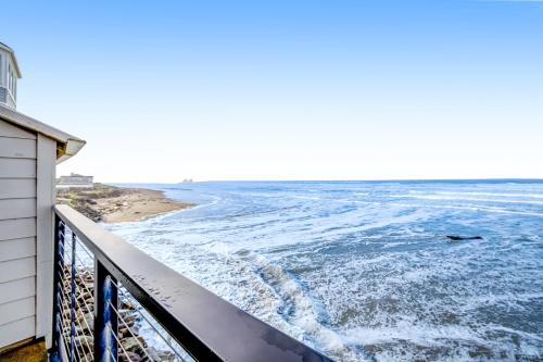 a view of the ocean from the balcony of a house at Beachy View at Rock Creek Inn in Rockaway Beach