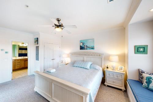 a bedroom with a bed and a ceiling fan at Sandy Cheeks #D2SC-H in Hatteras