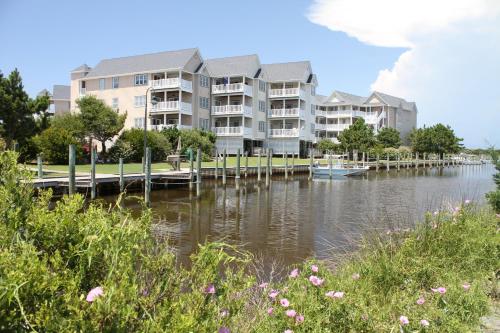 a large apartment building on the water with a dock at Sandy Cheeks #D2SC-H in Hatteras