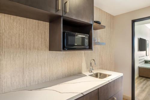 a kitchen with a sink and a microwave at Cambria Hotel Templeton - Paso Robles in Templeton